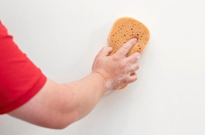 Washing the wall with sugar soap