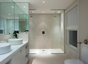Bathroom with double shower and double basin and white walls
