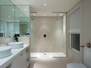Bathroom with double shower and double basin and white walls