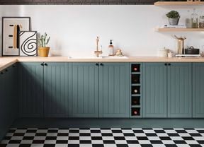 Kitchen with green cabinetry, wooden benchtop and gold tap. 