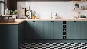 Kitchen with green cabinetry, wooden benchtop and gold tap. 