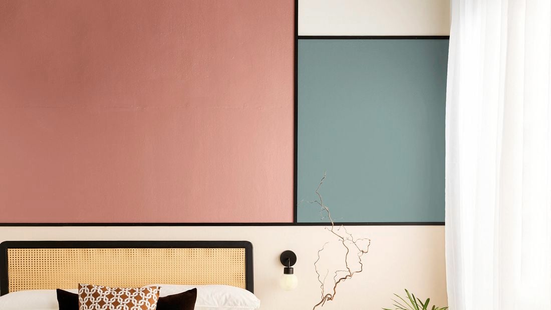   A close up of a wall in a bedroom using colour block interior design with two different colours.