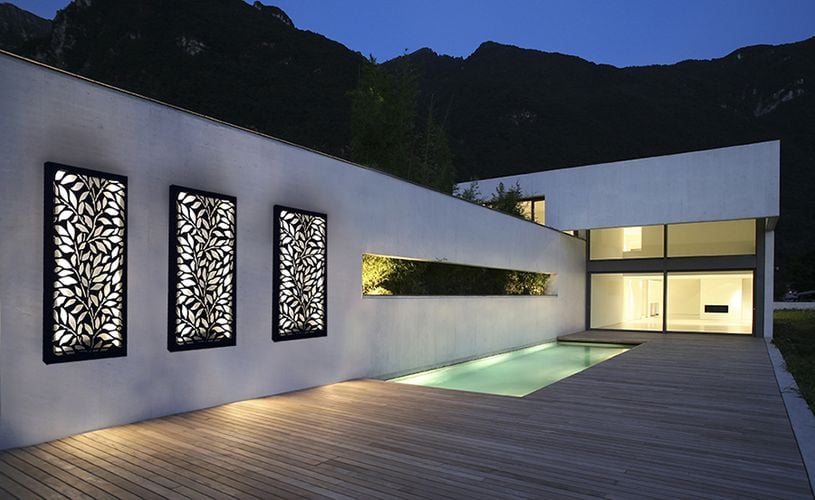 Timber decking by pool with decorative screening