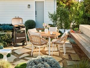 Outdoor styled setting on pavers and bbq. 
