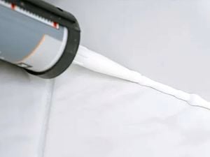 Adhesive product putting silicone in between tiles.