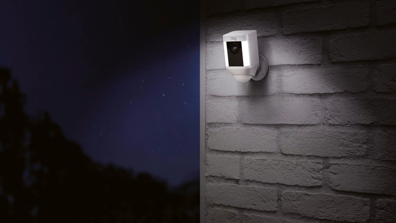 Ring Spotlight Cam on mounted on an external brick wall at night