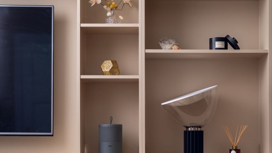 Stylish grey moisture absorber sitting on a bookshelf