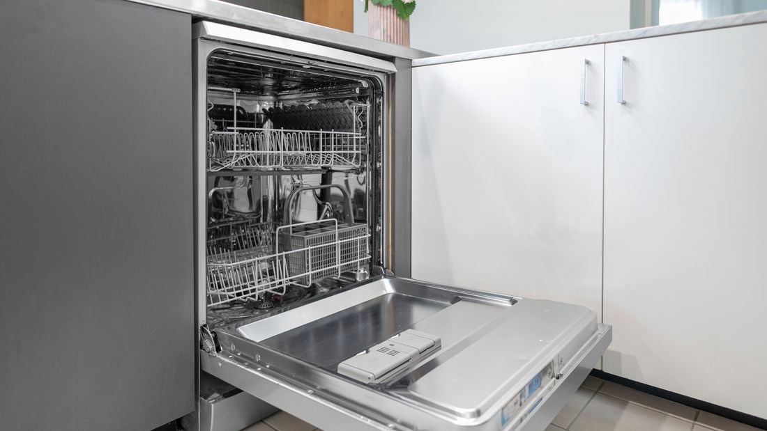 A dishwasher with the door open in a kitchen.