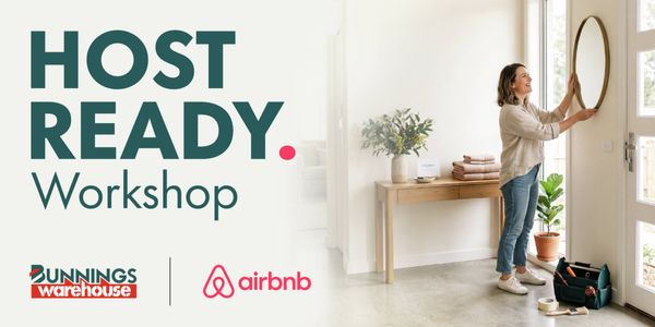 Promotional banner for the Bunnings Warehouse and Airbnb Host Ready Workshop. Large text reads “HOST READY. Workshop” alongside a photo of a person hanging a round mirror in a bright entryway. A wooden console table, potted plant, folded towels and a toolbox are visible. Bunnings Warehouse and Airbnb logos appear at the bottom.