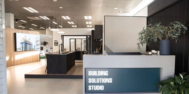 View of front desk with Building Solutions Studio sign on it.