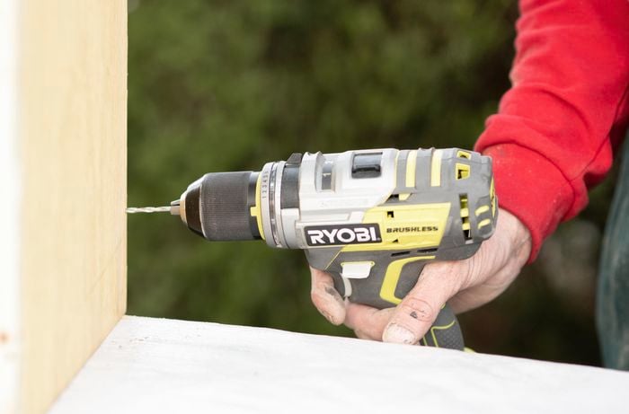 Holes being pre-drilled into a piece of timber