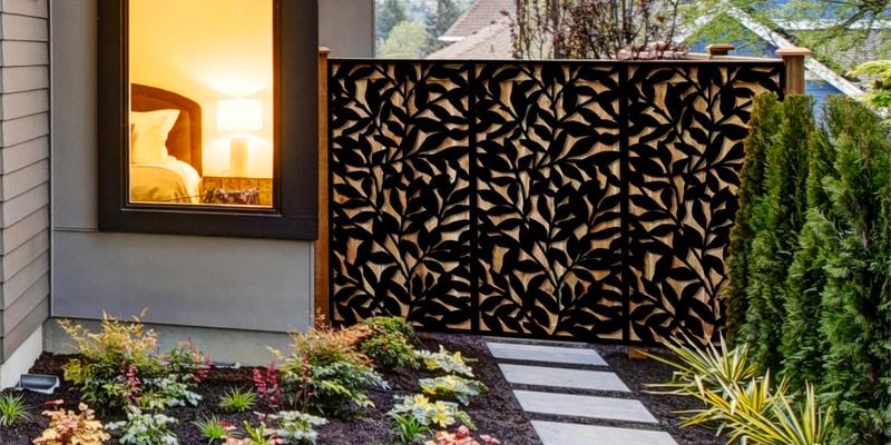 Garden screen installed against a backyard fence