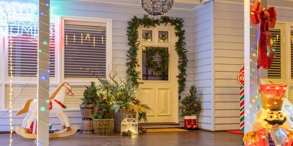 Front of house decorated with Christmas lights and decorations.