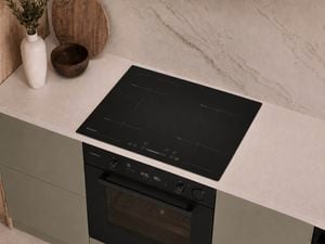 The sleek black glass finish cooktop integrates effortlessly into contemporary spaces.