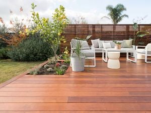 Outdoor furniture setting on a deck in the backyard of a house