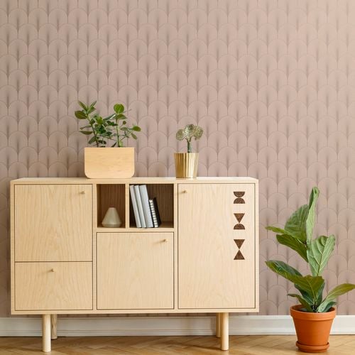 Scandi style cabinet in light timber with indoor plants and geometric wallpaper in a dusty pink.