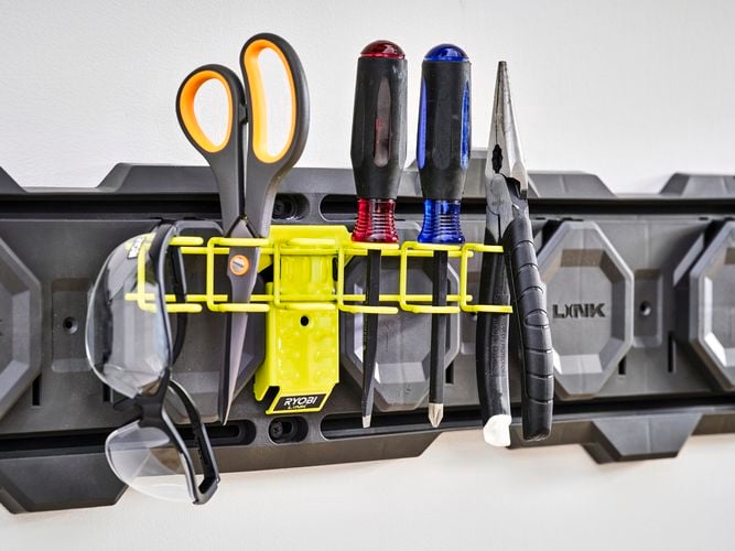 Wall plate with metal hook for screwdrivers.