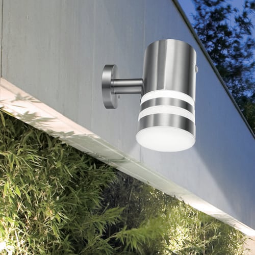 Wall mounted spotlight over greenery