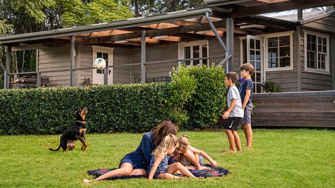 Group of people playing on a backyard lawn
