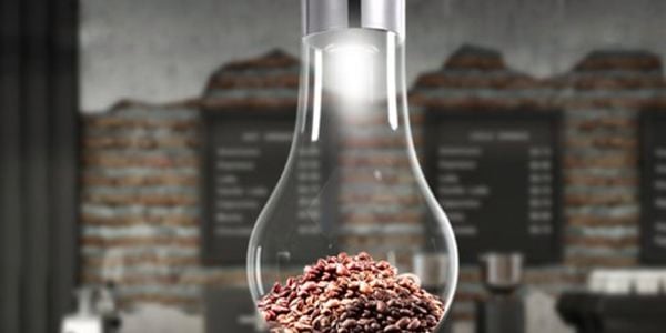 Light bulb shaped pendant light, with coffee beans inside.