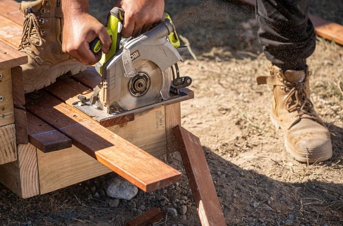 Overhanging lengths being cut from the secured decking boards