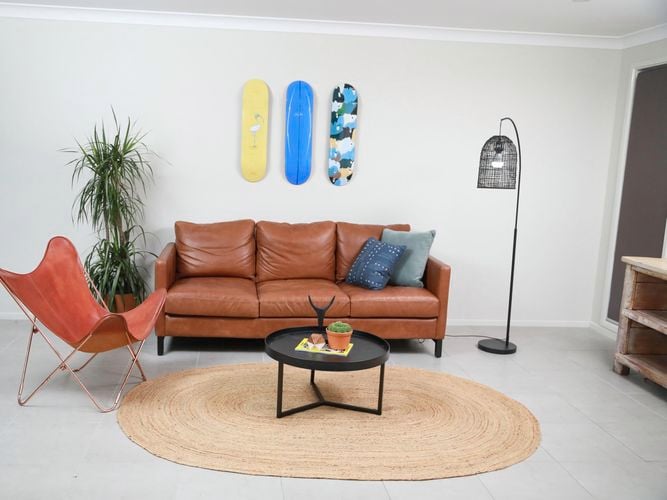 living room with skateboards on wall