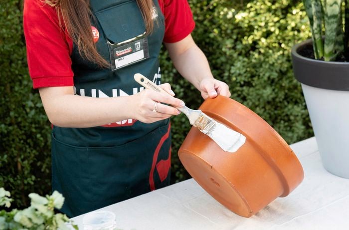 DIY - Step 4 - Team member painting pots - How to upcycle terracotta pots - Emily.jpg