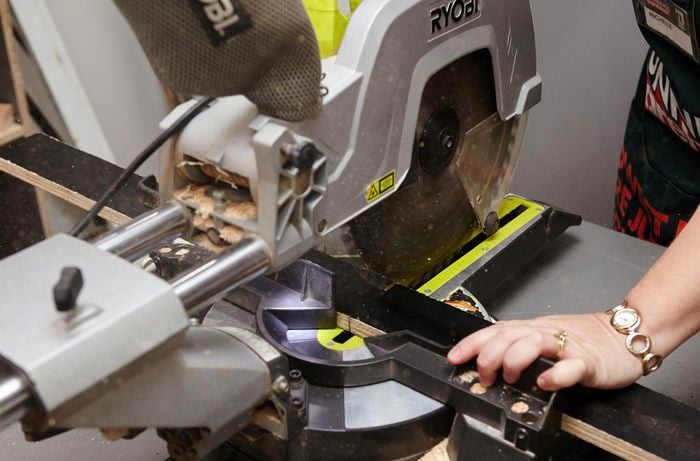 Person cutting form ply with circular saw.