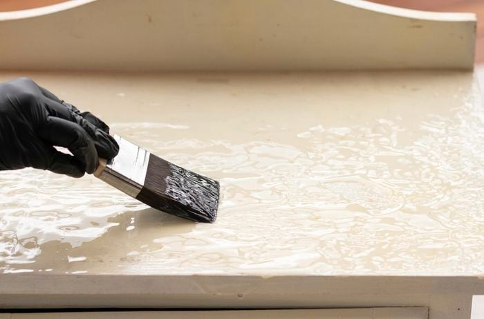 Apply Paint Stripper with a paint brush 