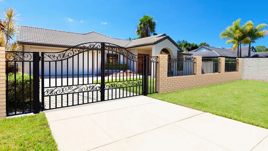 Steel gate and fence installed in front of cream house