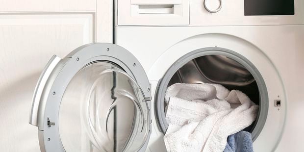 A washing basket on top of a washing machine.