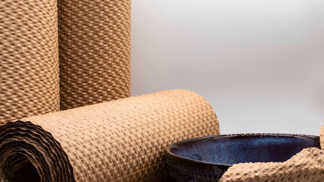 Paper bubble wrap rolls and a blue bowl.