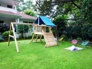 Playground and kids chairs placed in backyard
