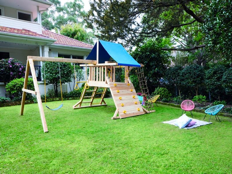 Playground and kids chairs placed in backyard