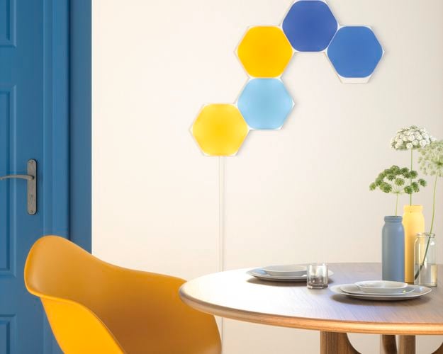 5 smart light panel layout mounted onto a wall beside a dining room table.