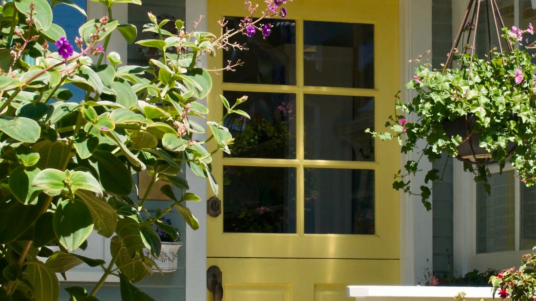 A house facade with a yellow door