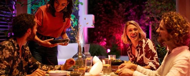 Couples enjoying dinner together outside with mood lighting