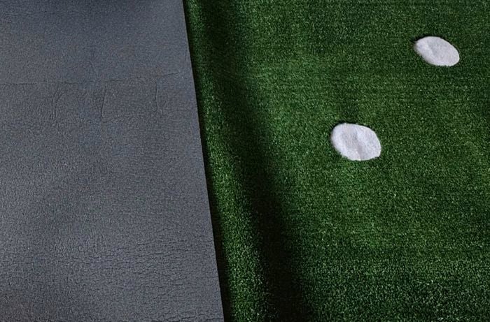 A foam mat next to a turf mat with a white circle being made into an indoor putting green]