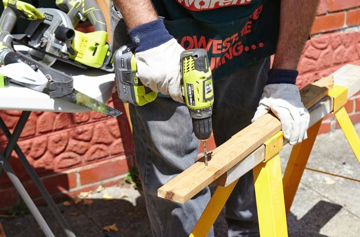 Person drilling into bit of timber.