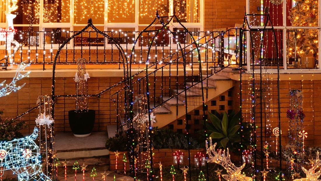 A garden decorated with plant trainers wrapped in solar fairy lights.   