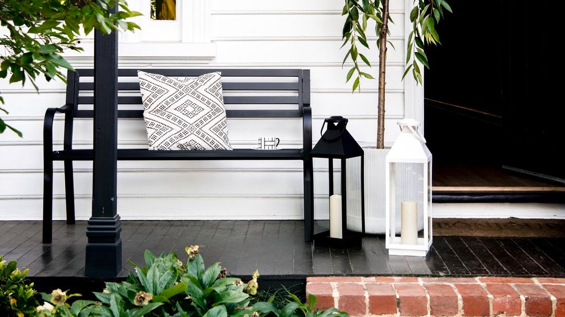 Front porch of house with bench and plants