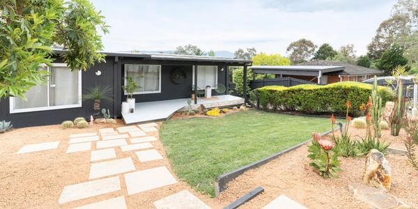 Revealed front yard and house with pavers, turf, native hardy plants and hedging