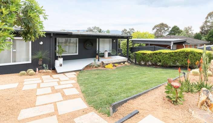 Revealed front yard and house with pavers, turf, native hardy plants and hedging