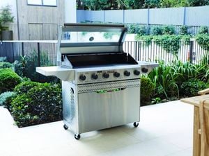 BBQ with open lid in backyard