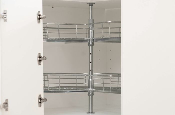 corner cabinet with its doors open, revealing a rotating basket unit installed inside