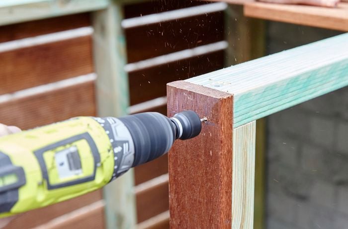 Person drilling timber together.