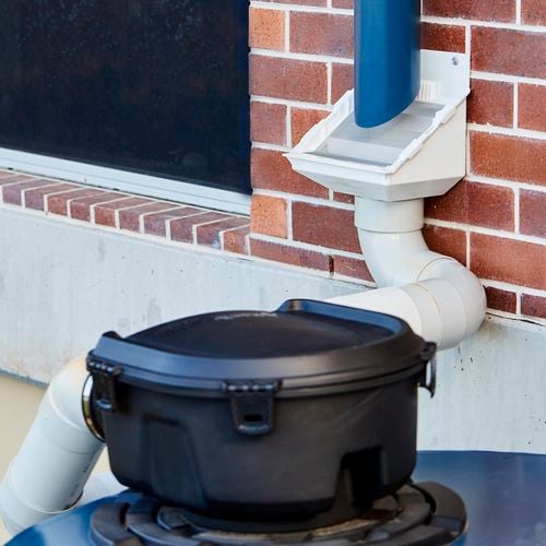 Close up of downpipe on brick wall.