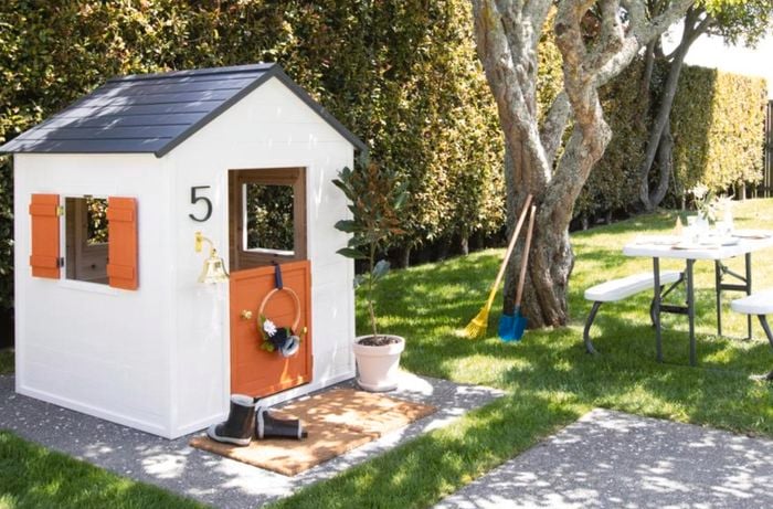 Cubby house painted in white and orange.