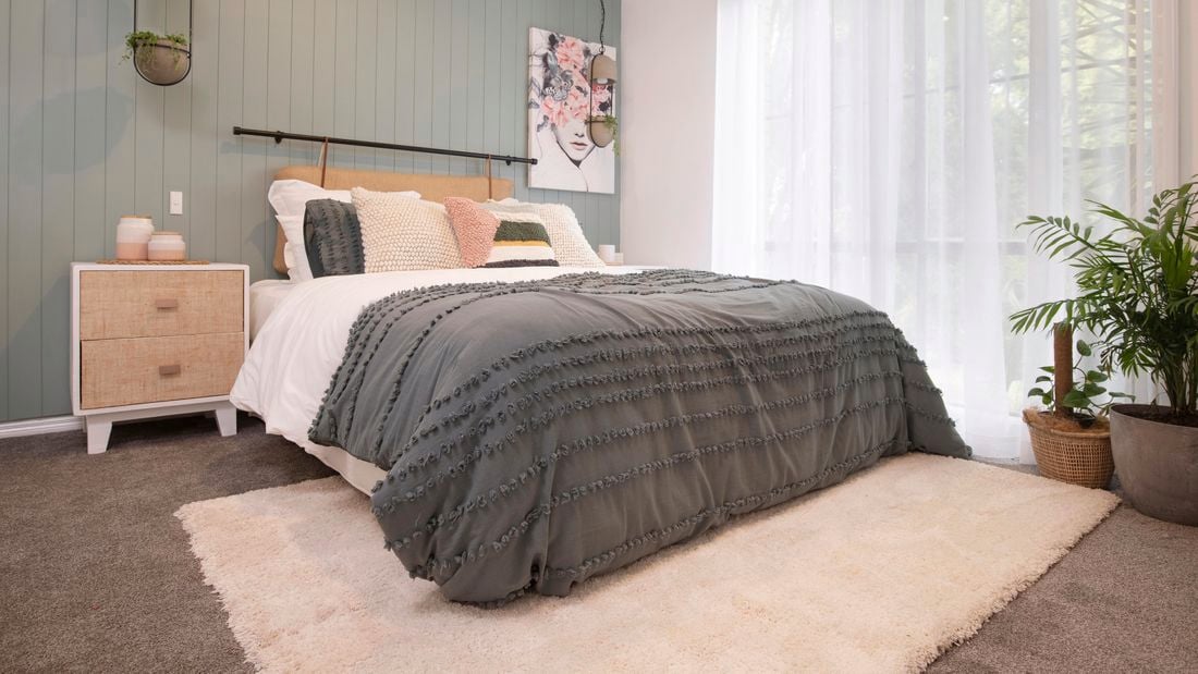 Beige rug in a bedroom setting.