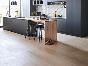 Black kitchen cabinets and island with a timber benchtop feature